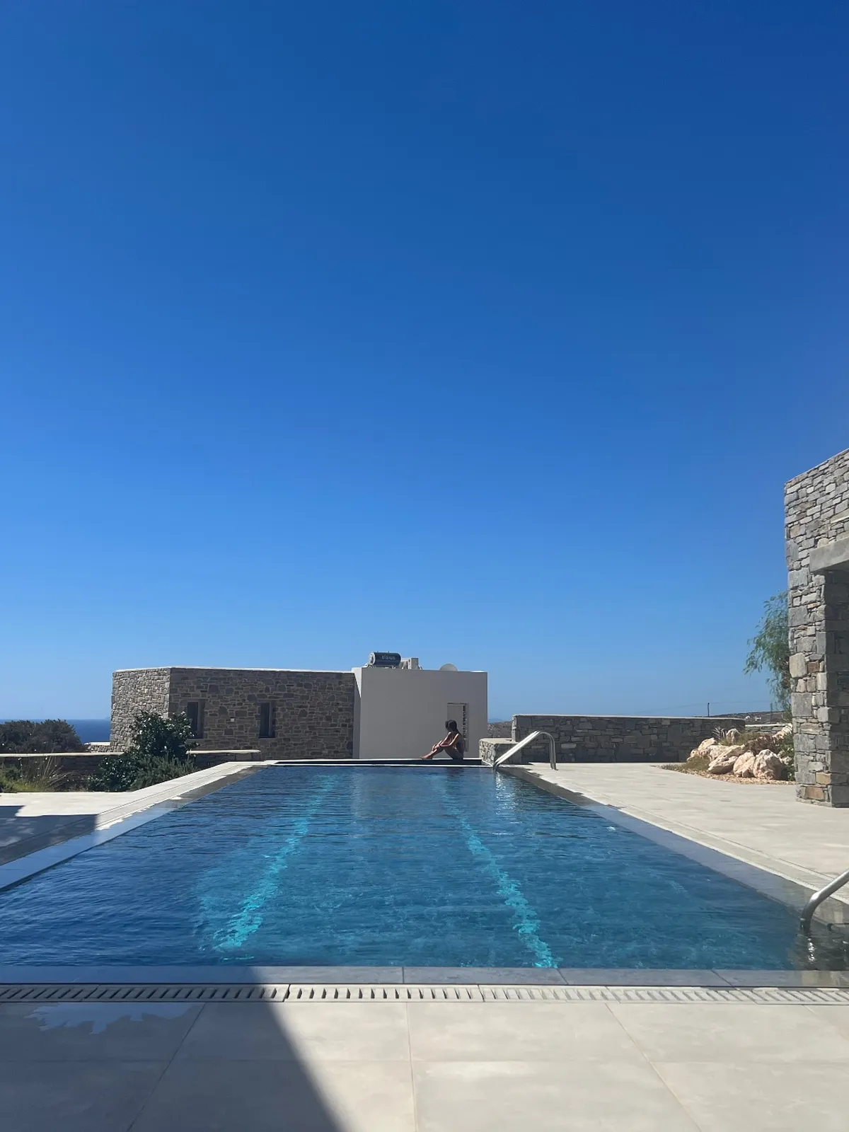 Garden Suite — shared infinity pool overlooking the aegean