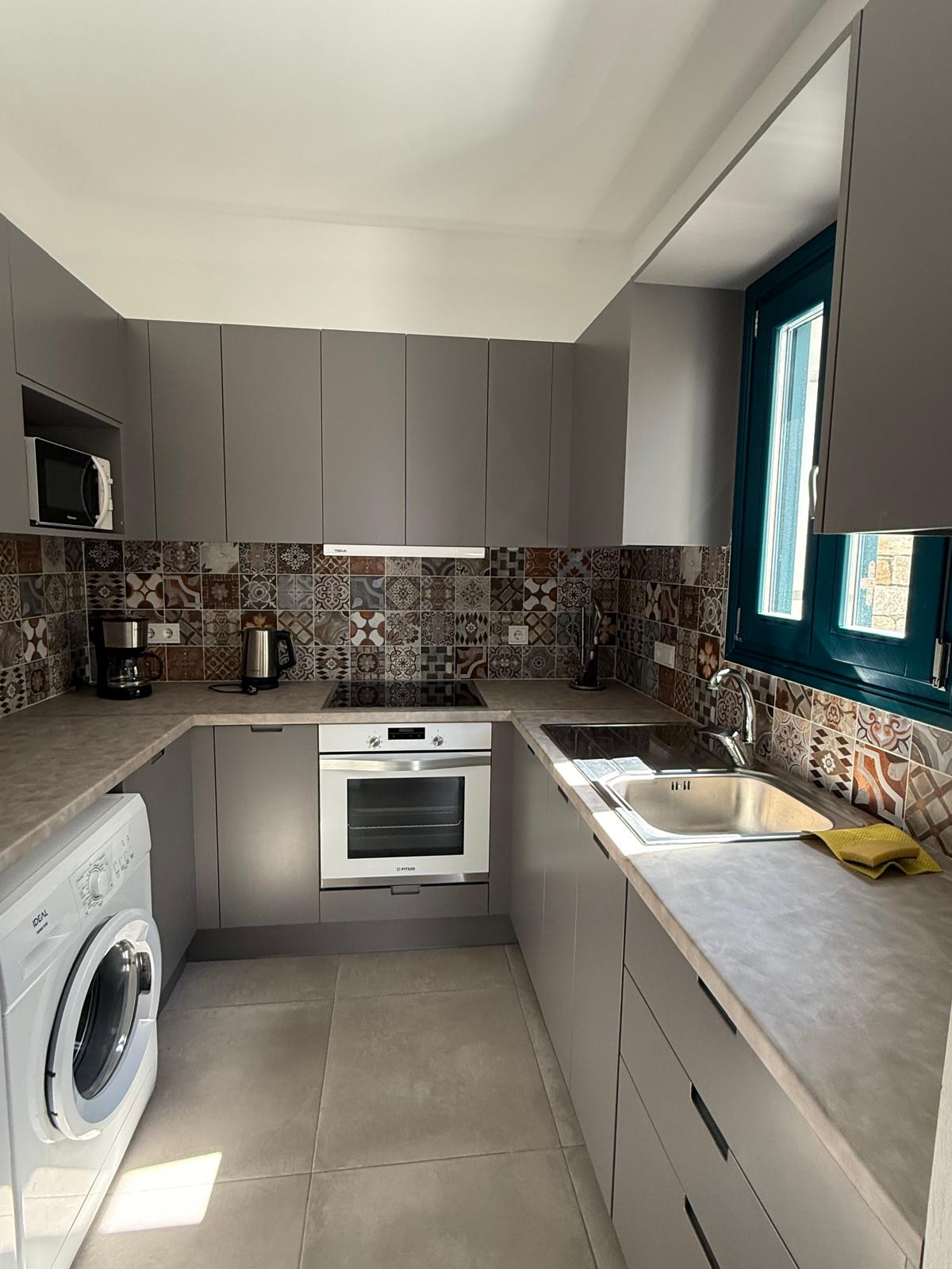 Garden Suite — fully equipped kitchen with laundry