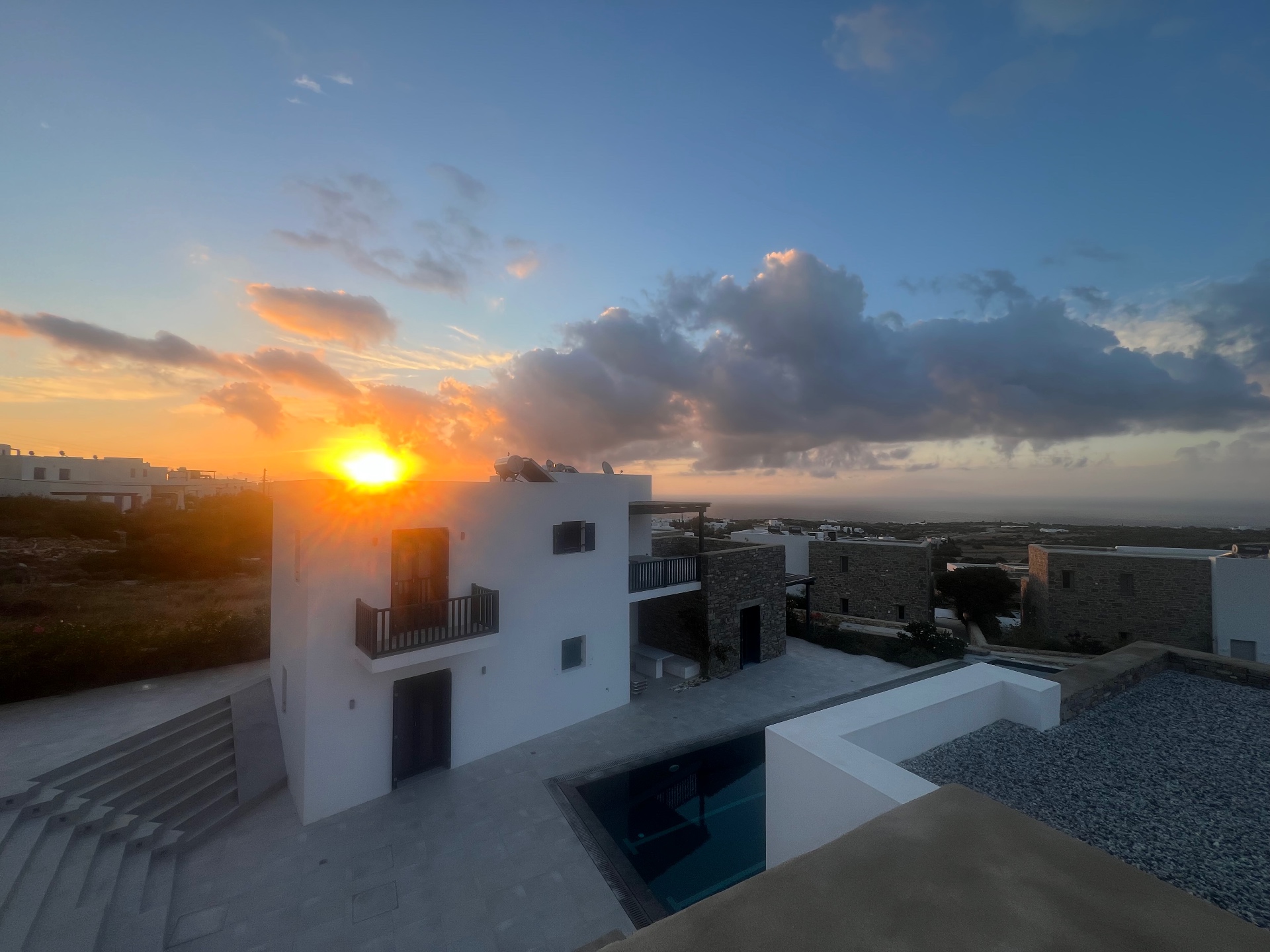 Sky Suite — sunset view over the complex and pool